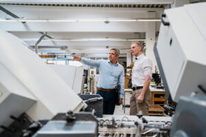 two colleagues talking in a factory